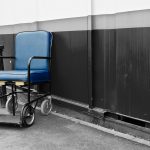 Empty, blue mobility equipment in London against a wall.